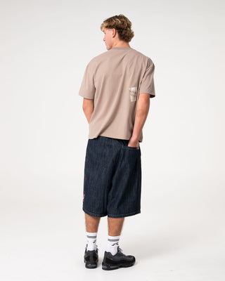 Man wearing Uncut Gems Short Sleeve Tee in Mushroom