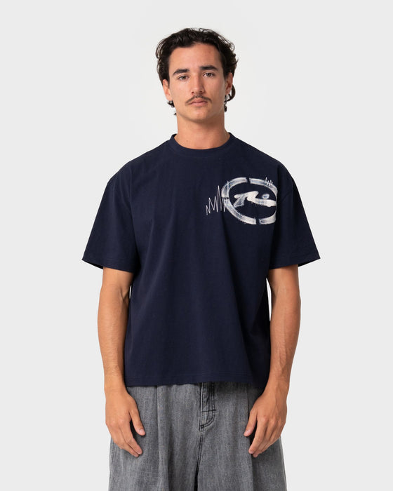 man-wearing-uncut-gems-short-sleeve-tee-in-navy-blue