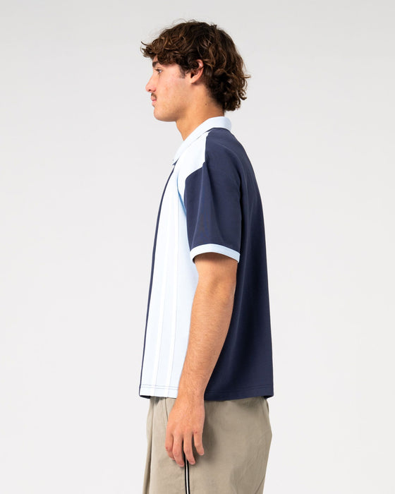 man-wearing-prestige-short-sleeve-polo-in-navy-blue