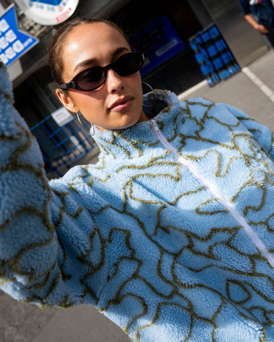 Woman wearing Low Tides Zip Through Sherpa Fleece in Tranquil Blue