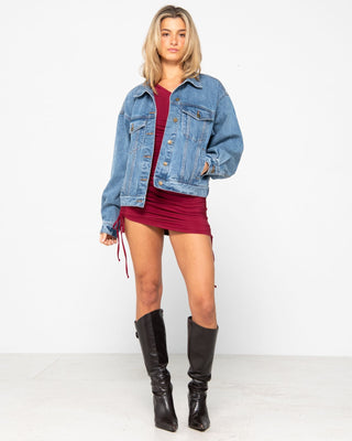 Woman wearing Lani Rouched One Shoulder Mini Dress in Rhubarb