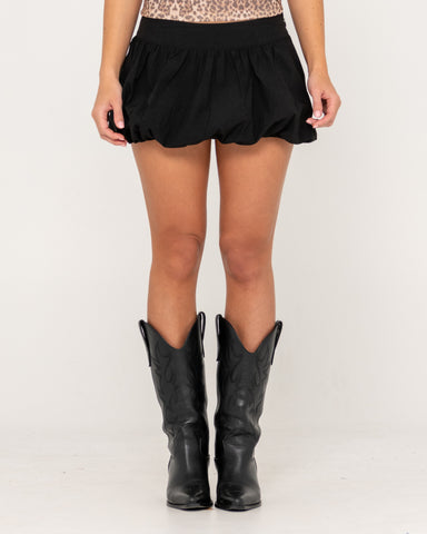 Woman wearing Brat Bubble Hem Mid Rise Mini Skirt in Black