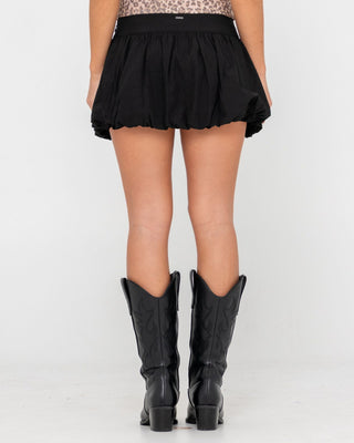 Woman wearing Brat Bubble Hem Mid Rise Mini Skirt in Black