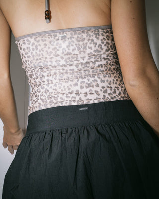 Woman wearing Brat Bubble Hem Mid Rise Mini Skirt in Black