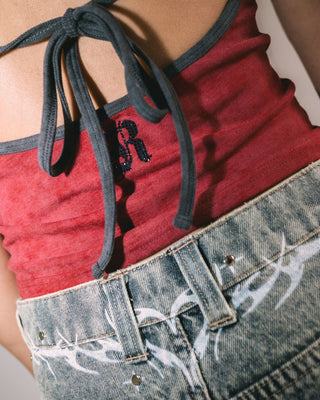 Woman wearing X-tina Pheonix Low Rise Denim Mini Short in Dirty Dawg