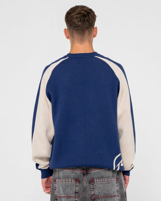 Man wearing Roll Safe Boxy Knitted Crew in Dark Blue