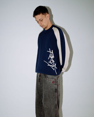 Man wearing Roll Safe Boxy Knitted Crew in Dark Blue