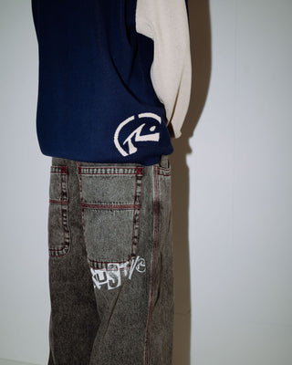 Man wearing Roll Safe Boxy Knitted Crew in Dark Blue