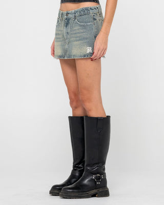 Woman wearing Morty Low Rise Denim Micro Mini Skirt in Dirty Dawg
