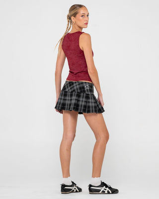 Woman wearing Plaidnani Low Rise Pleated Skirt in Carbon Plaid
