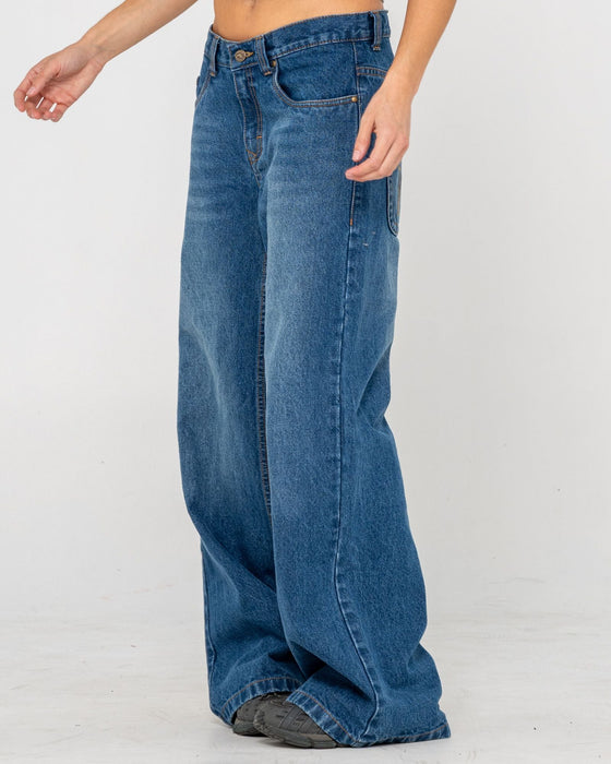 woman-wearing-rip-in-wendy-wide-low-rise-denim-jean-in-blasted-deep-sea-blue