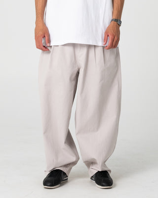 Man wearing Enigma Pleated Pant in Stone