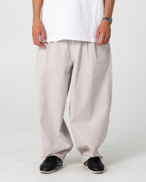 man-wearing-enigma-pleated-pant-in-stone