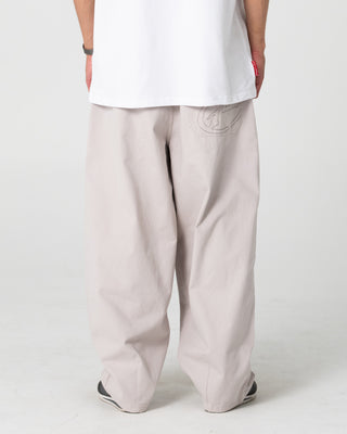 Man wearing Enigma Pleated Pant in Stone