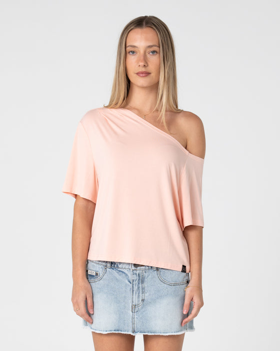 woman-wearing-sally-slouch-off-shoulder-tee-in-peach-pink