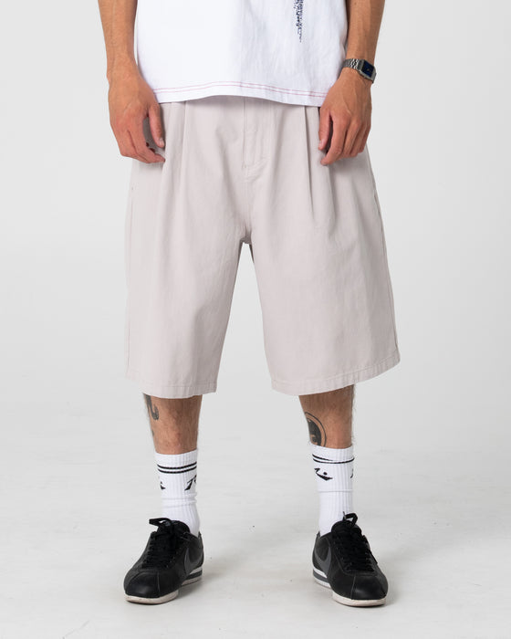 man-wearing-enigma-pleated-short-in-stone