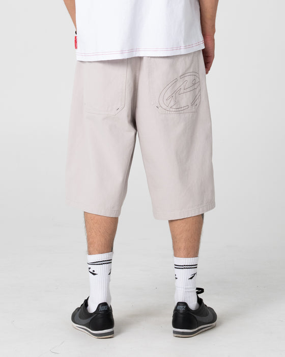 man-wearing-enigma-pleated-short-in-stone