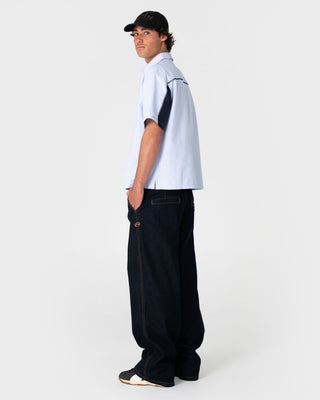 Man wearing Cashflow Pleated Baggy Jean in Raw Dawg Blue