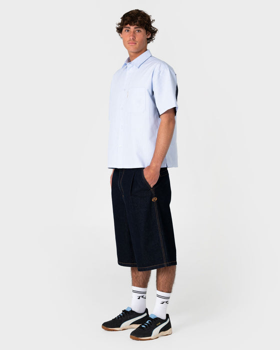 man-wearing-cashflow-pleated-jort-in-raw-dawg-blue