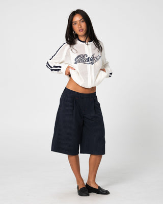 Woman wearing Eugene Zip Through Knit in Egret / Navy Blue
