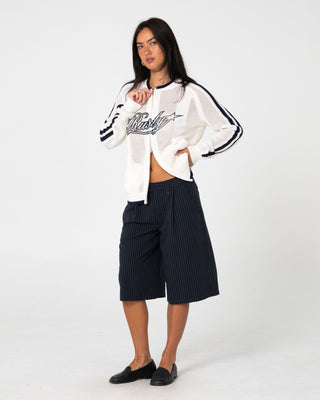 Woman wearing Eugene Zip Through Knit in Egret / Navy Blue