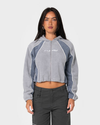 Woman wearing Mini Two Tides Zip Through Polar Fleece in Grey / Atlantic Blue
