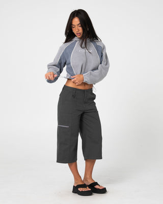 Woman wearing Mini Two Tides Zip Through Polar Fleece in Grey / Atlantic Blue