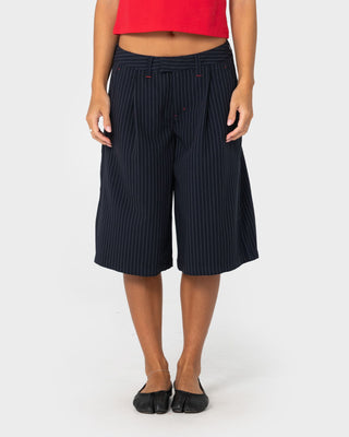 Woman wearing Big Bad Finance Mommy Low Rise Short in Navy Pinstripe