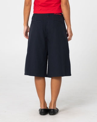 Woman wearing Big Bad Finance Mommy Low Rise Short in Navy Pinstripe