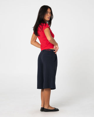Woman wearing Big Bad Finance Mommy Low Rise Short in Navy Pinstripe