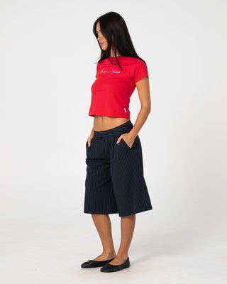 Woman wearing Big Bad Finance Mommy Low Rise Short in Navy Pinstripe