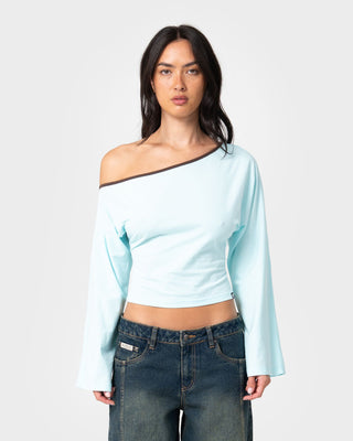 Woman wearing Yuno Reverse Long Sleeve Slouch Top in Powder Aqua