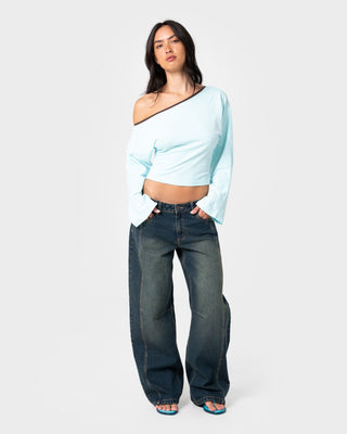 Woman wearing Yuno Reverse Long Sleeve Slouch Top in Powder Aqua