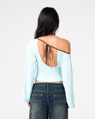 Woman wearing Yuno Reverse Long Sleeve Slouch Top in Powder Aqua