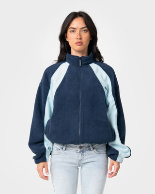 Woman wearing Two Tides Zip Through Sherpa Fleece in Navy /Light Blue