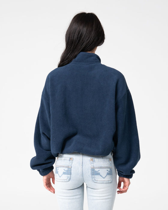 woman-wearing-two-tides-zip-through-sherpa-fleece-in-navy-light-blue