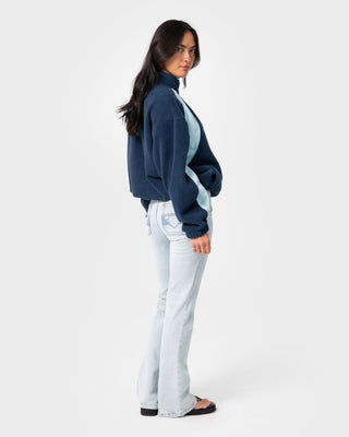 Woman wearing Two Tides Zip Through Sherpa Fleece in Navy /Light Blue