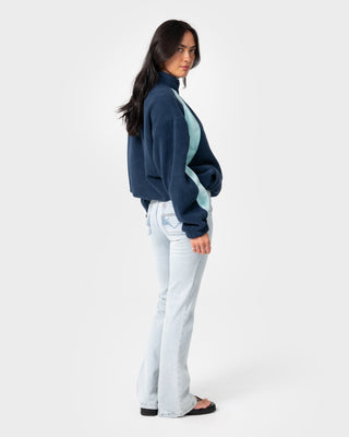 Woman wearing Two Tides Zip Through Sherpa Fleece in Navy / Light Blue