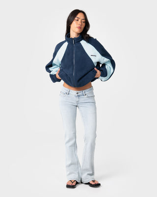 Woman wearing Two Tides Zip Through Sherpa Fleece in Navy /Light Blue