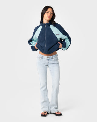 Woman wearing Two Tides Zip Through Sherpa Fleece in Navy / Light Blue