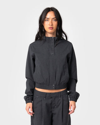 Woman wearing Road Rage Hardstyle Funnel Neck Jacket in Coal Pinstripe