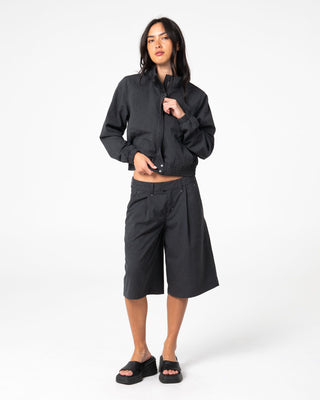 Woman wearing Road Rage Hardstyle Funnel Neck Jacket in Coal Pinstripe