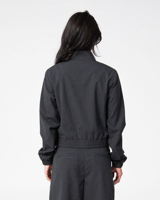 Woman wearing Road Rage Hardstyle Funnel Neck Jacket in Coal Pinstripe