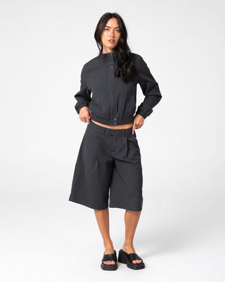 Woman wearing Road Rage Hardstyle Funnel Neck Jacket in Coal Pinstripe