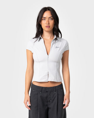 Woman wearing Siren Zip Through Short Sleeve Shirt in Ultimate Grey
