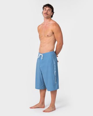 Man wearing Dragon Boosta Fixed Waist Boardshort in Shadow Blue