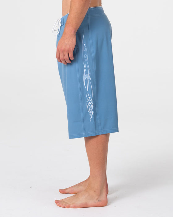 man-wearing-dragon-boosta-fixed-waist-boardshort-in-shadow-blue