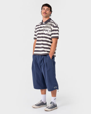 Man wearing Thrasha Short Sleeve Polo in Carbon
