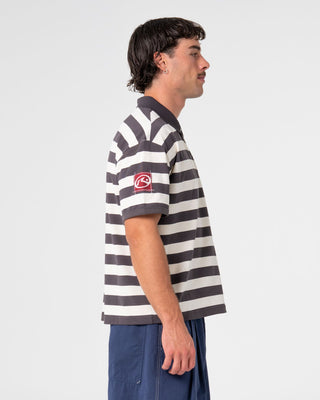 Man wearing Thrasha Short Sleeve Polo in Carbon
