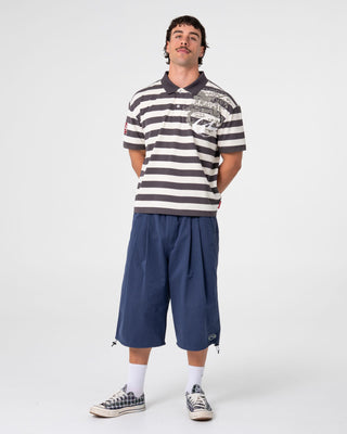 Man wearing Thrasha Short Sleeve Polo in Carbon
